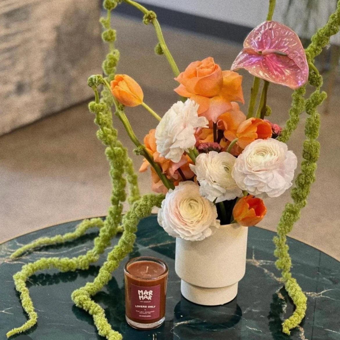modern pedestal vase in cream ceramic with arrangement on marble table