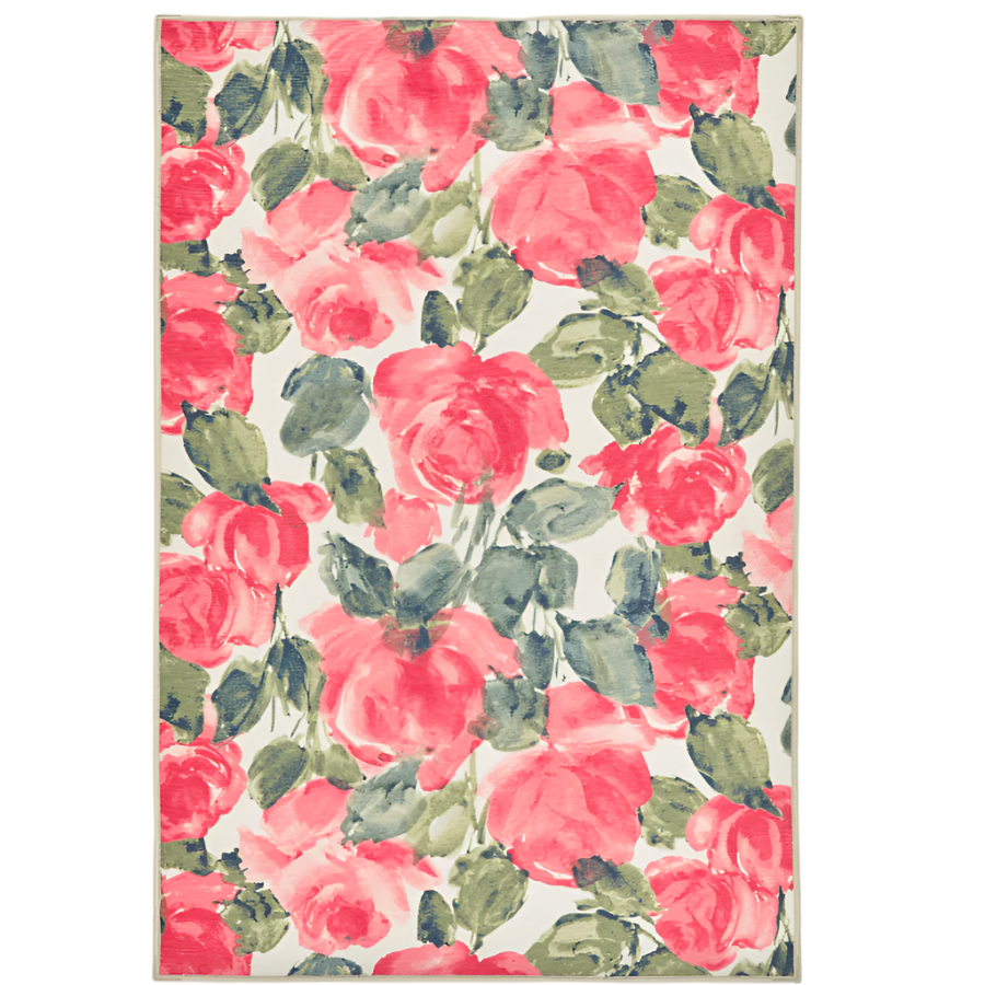 A rectangular rug with a floral pattern consisting of red and pink peonies and green leaves on a beige background.