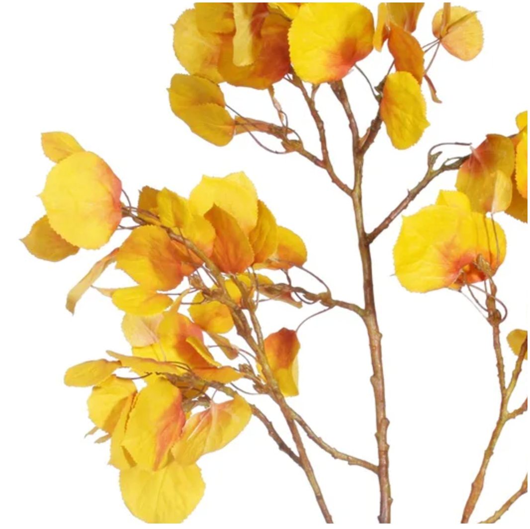 Artificial yellow leaf branch on a white background