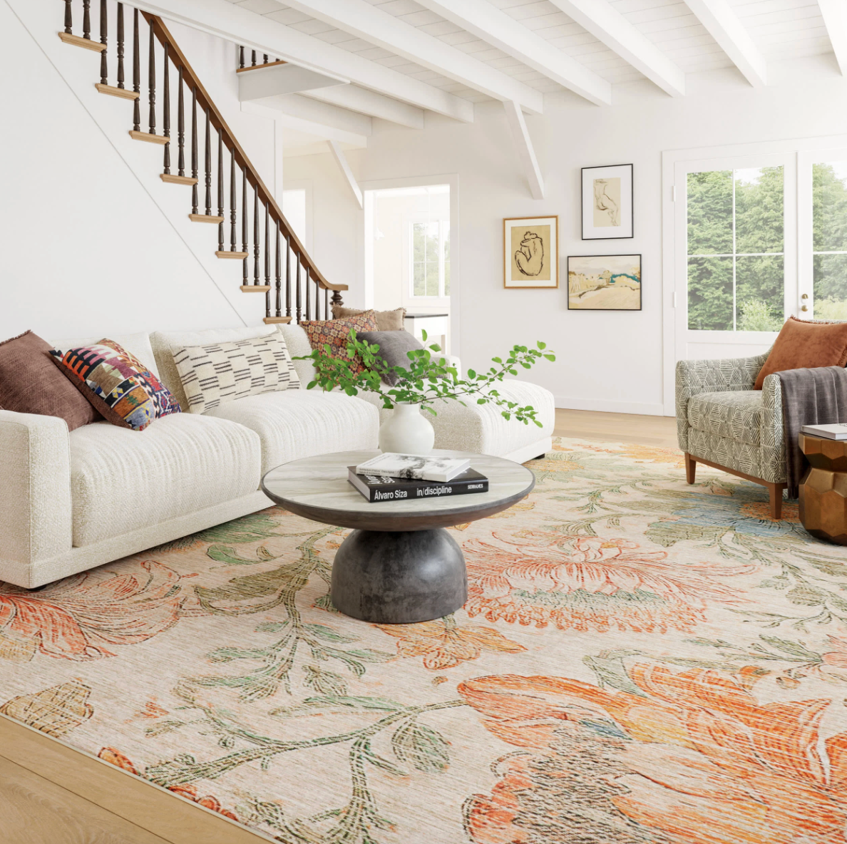 Living room with a floral rug, white sofa, and wooden coffee table.