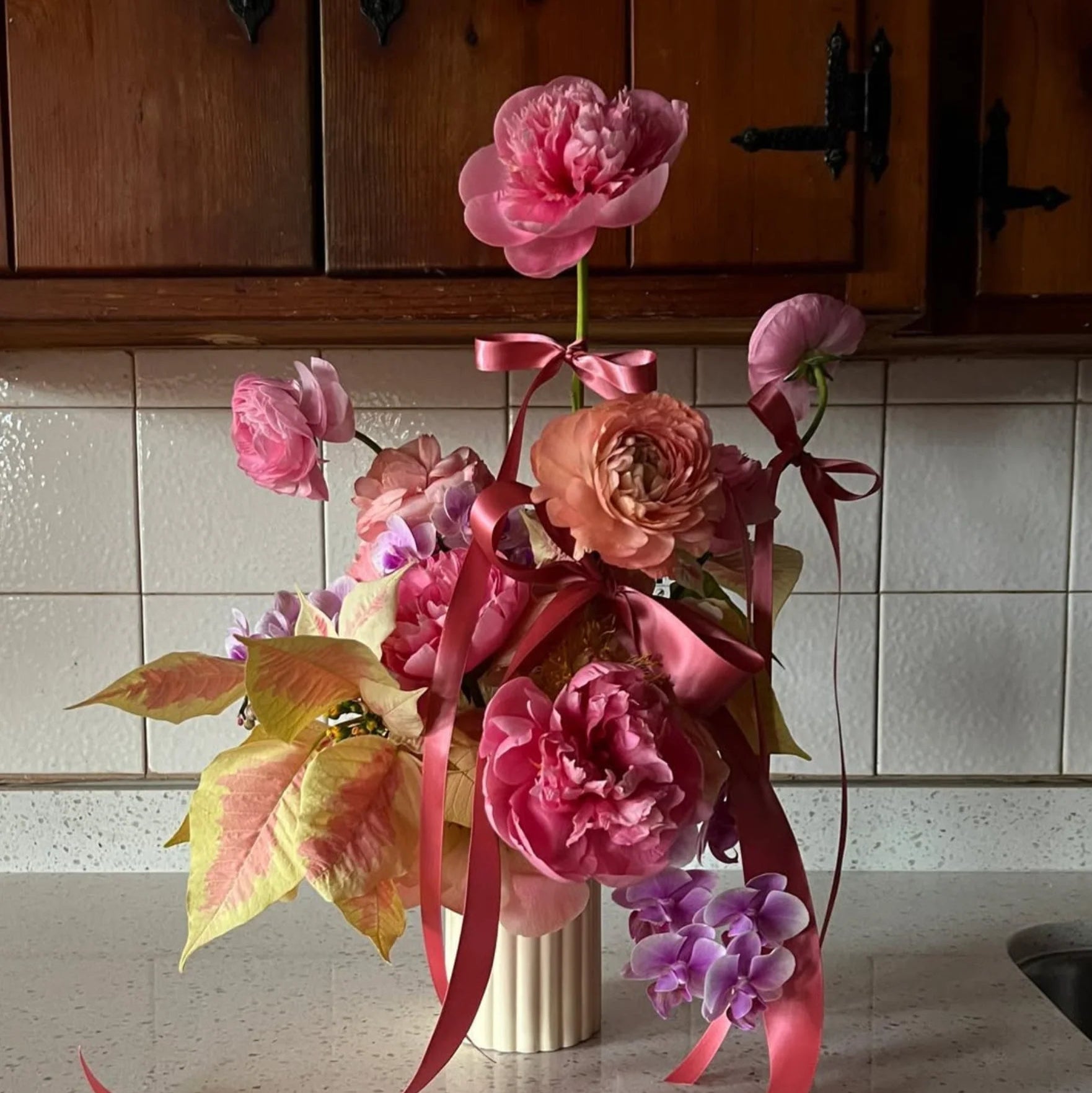 Daisy cylinder vase with floral on kitchen counter