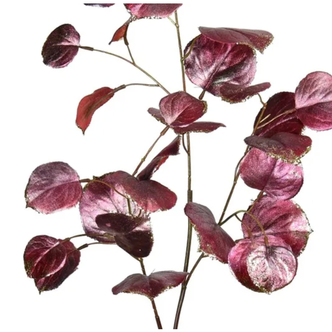 Artificial purple leaf branch on a white background