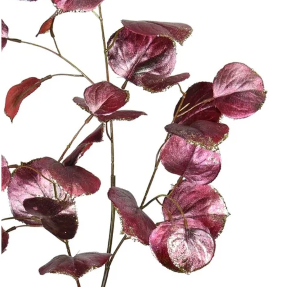 Artificial purple leaf branch on a white background