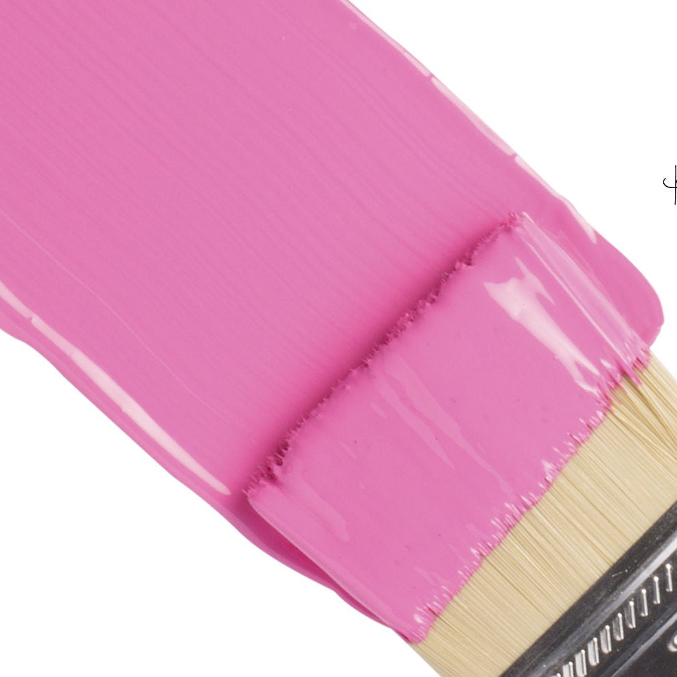 Pink paintbrush with Fusion Curiously Pink paint on a white background