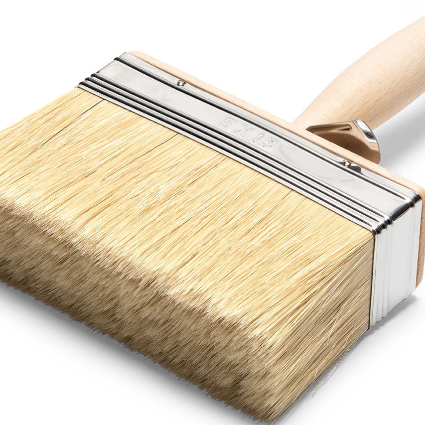 Brush with wooden handle and bristle head on a white background