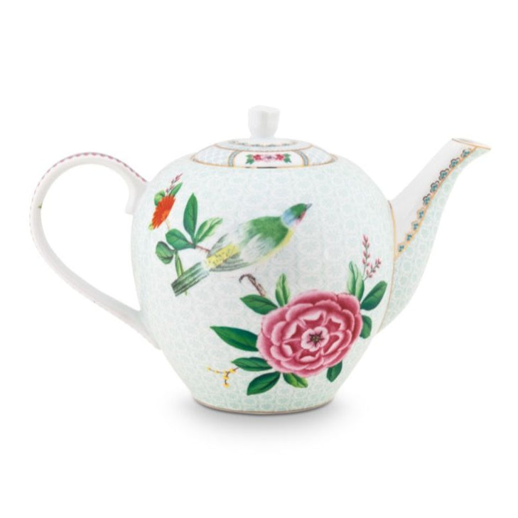 White teapot with floral and cactus designs on a white background
