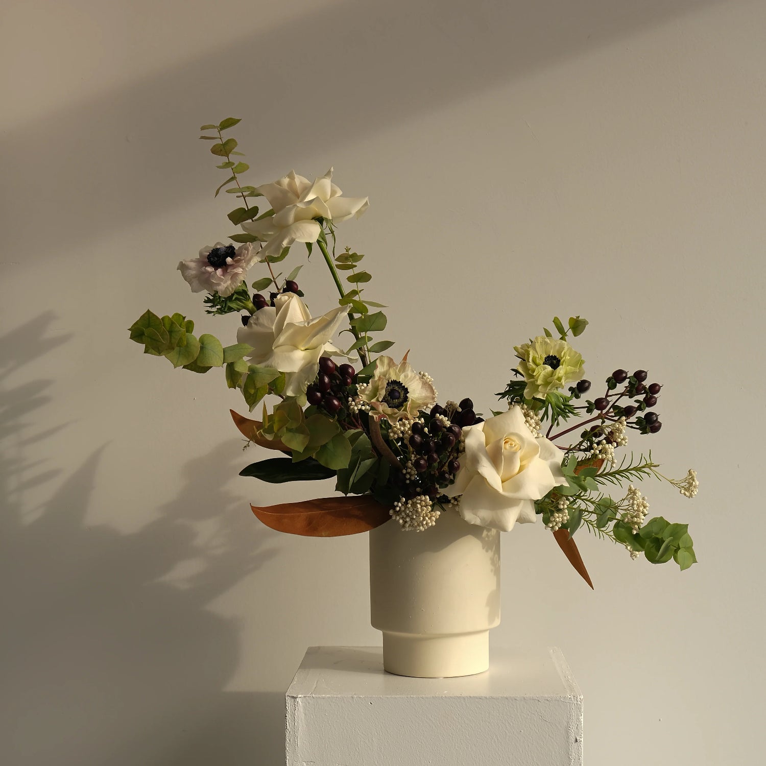 Modern pedestal vase with floral arrangement 
