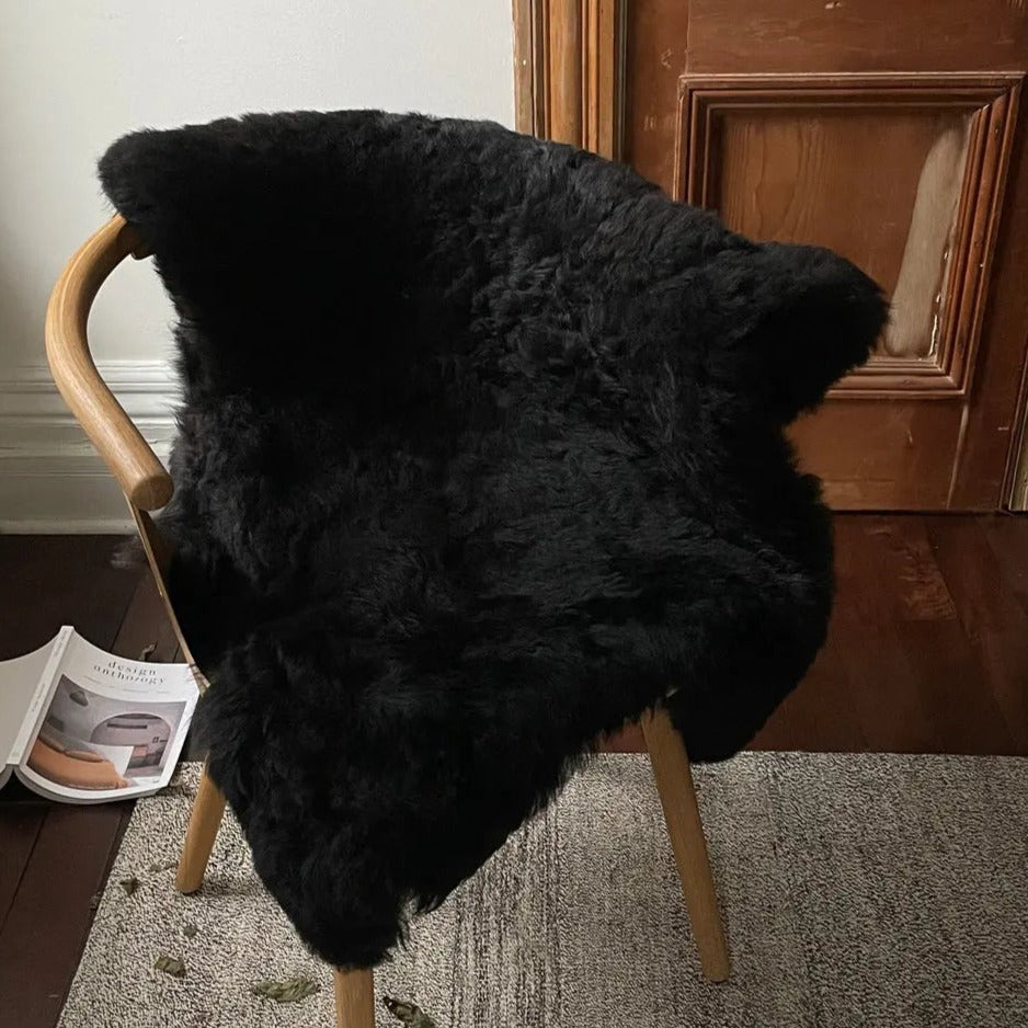 Home Smith Icelandic Sheepskin Throw in Shorn Black Black Sheep White Light Inc. Throws