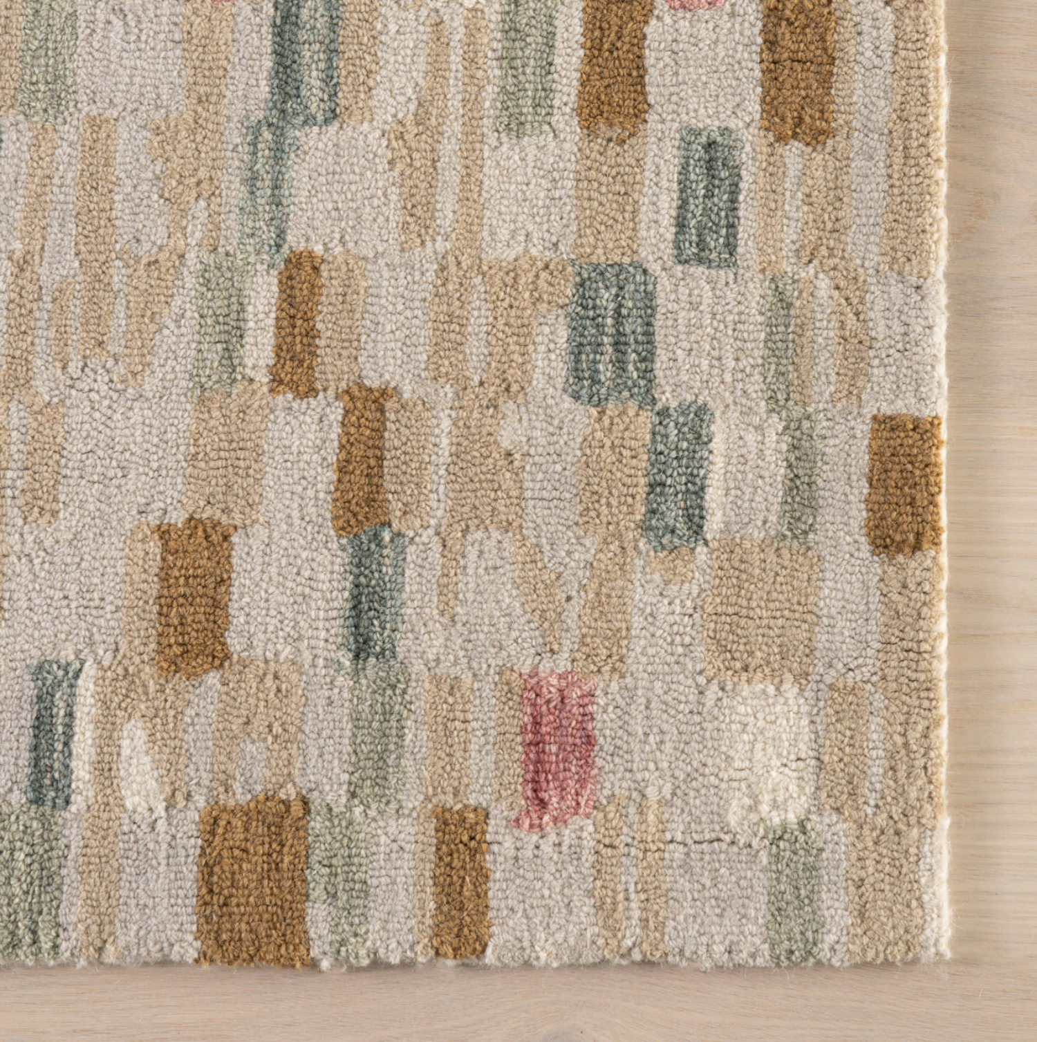 Textured area rug with geometric pattern on a wooden floor