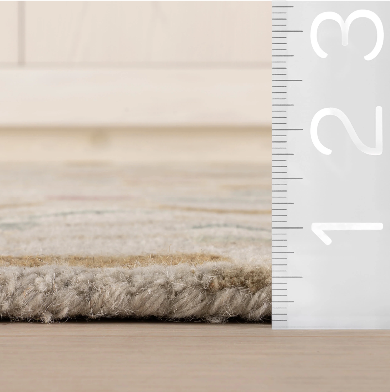 Close-up of a textured rug with a ruler on the side for scale.