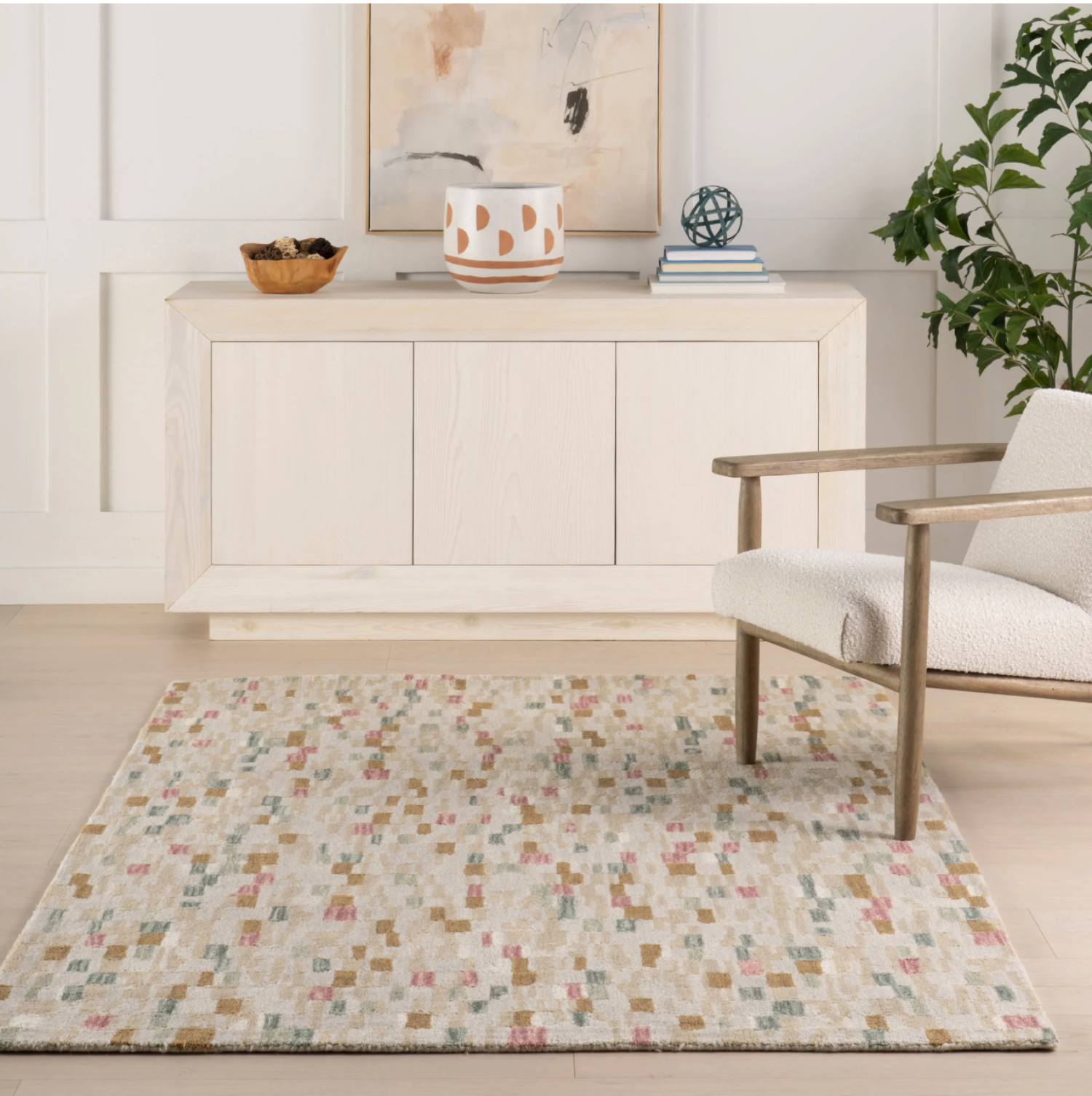 Living room with a patterned rug, armchair, and sideboard.
