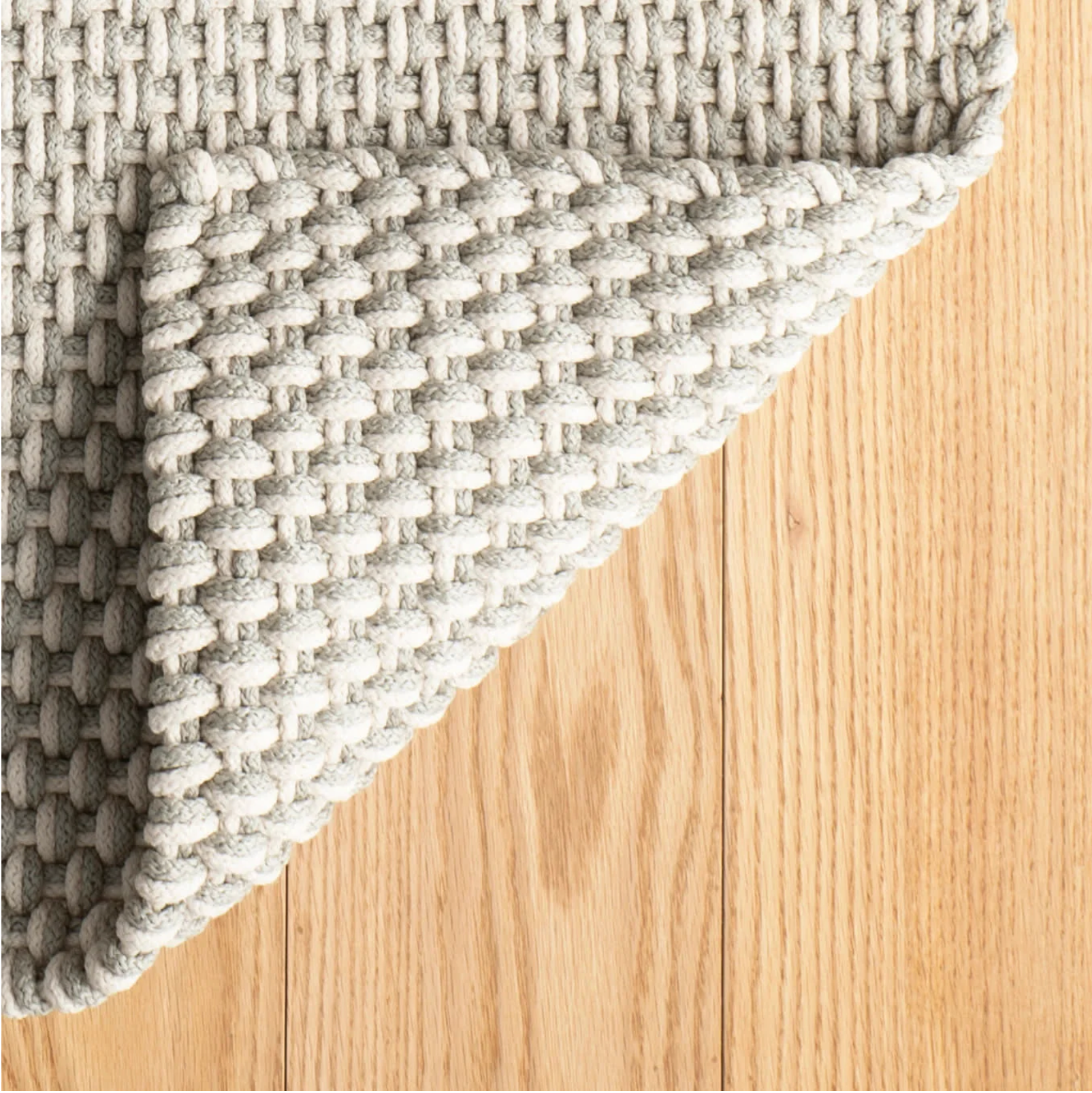 Textured gray rug on a wooden floor
