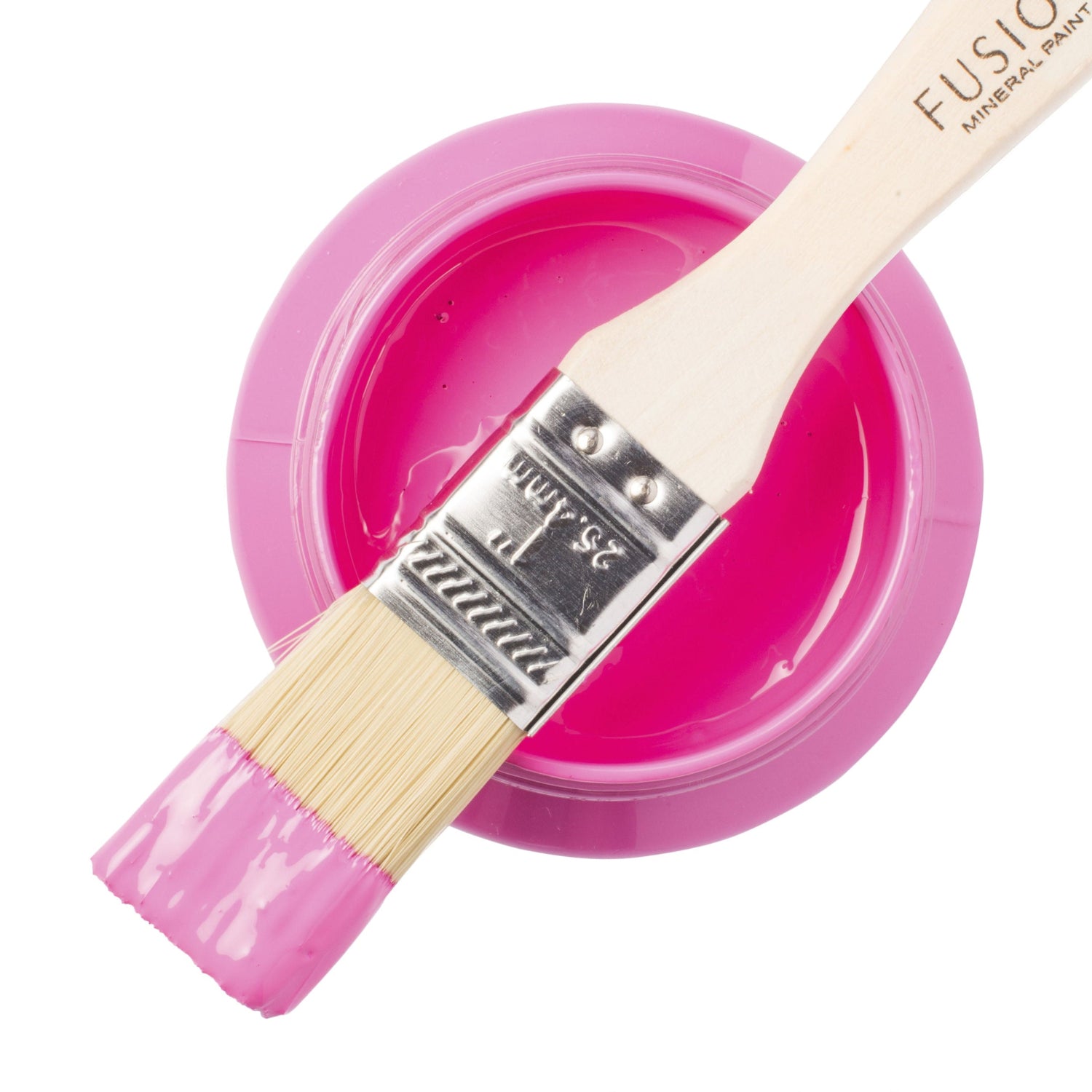 Pink paint with a brush and container on a white background