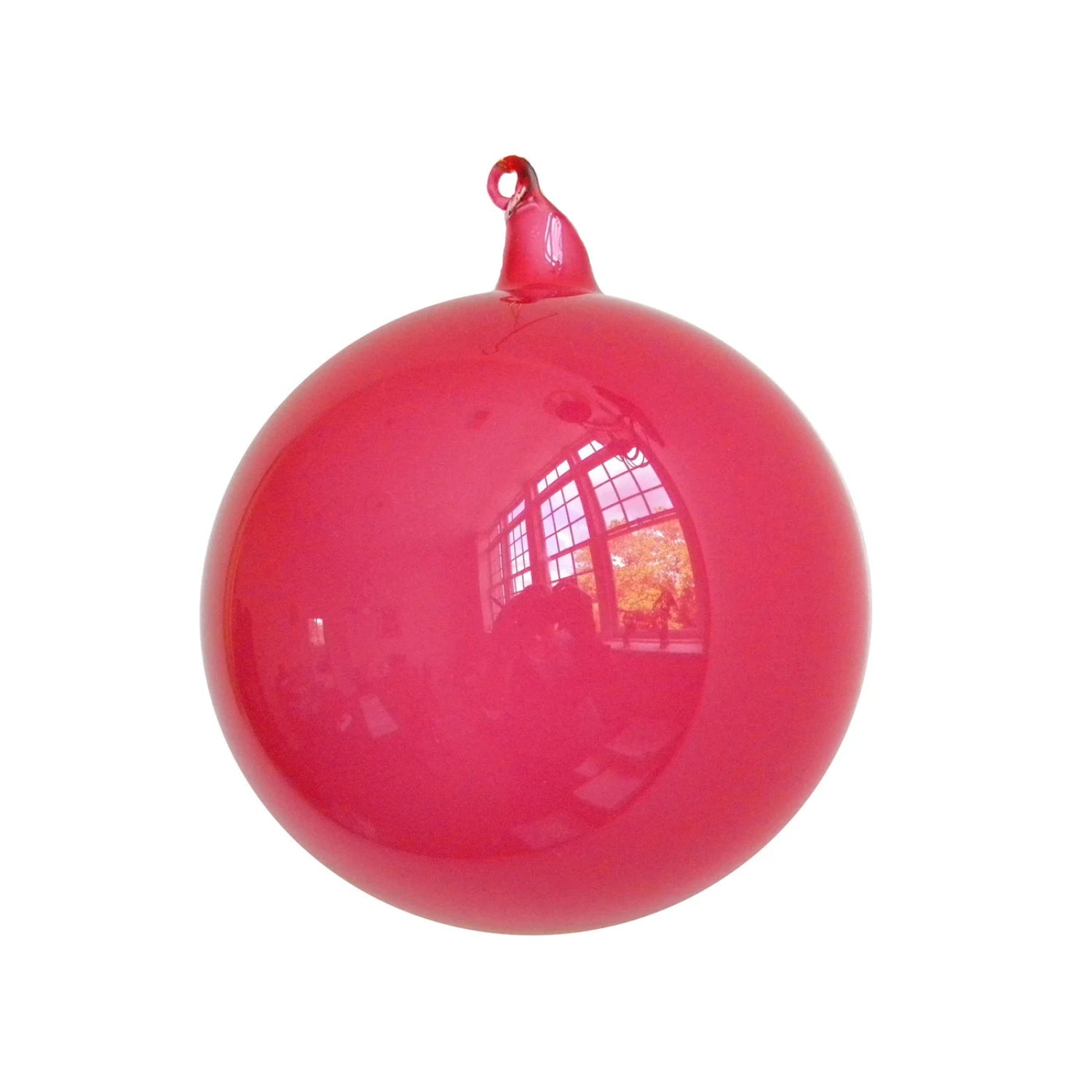 Glossy pink ball with a small red cap on a white background