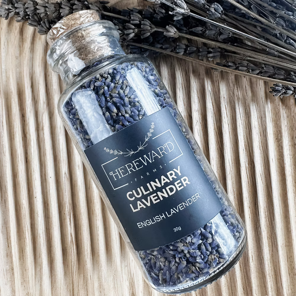 Glass bottle of culinary lavender with a label on a wooden surface