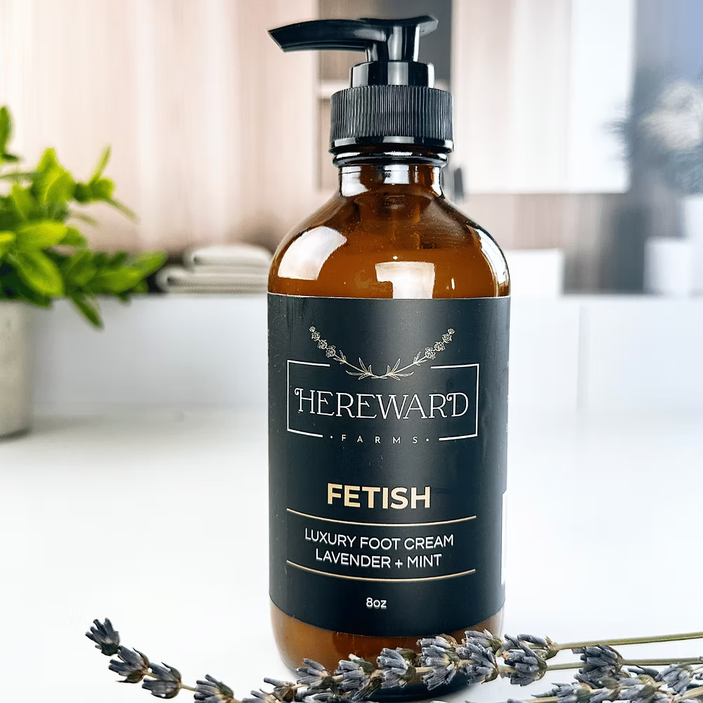 Bottle of Hereward Farms Fetish Luxury Foot Cream with lavender and mint on a blurred background